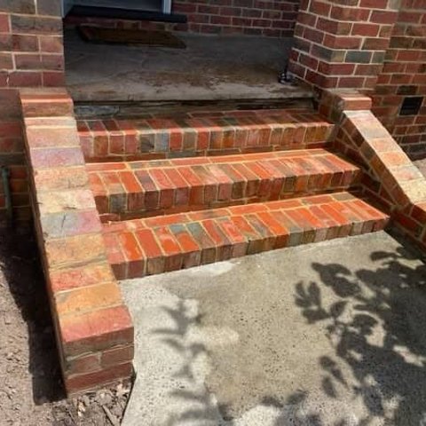 Three red brick entrance steps with rowlock treads and side walls