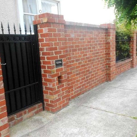 Red brick front fence with pillars, metal gate and integrated letterbox