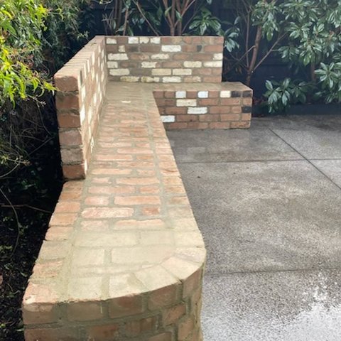 Custom L shaped recycled brick garden bench with curved end