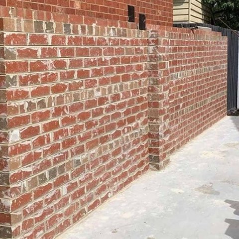 Red brick boundary wall with structural pillar on a residential site