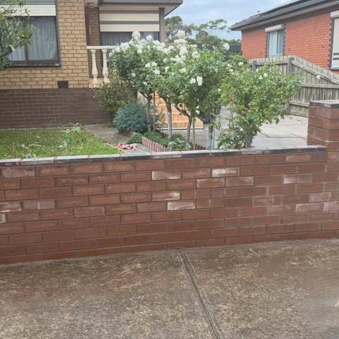 Red brown brick front fence with integrated letterbox pillar