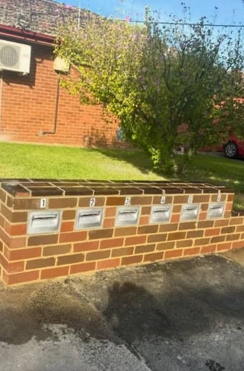 Multi brick mailbox wall with six integrated letterboxes