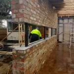 Floating brick work over black framed windows by Alternative Bricklaying Floating brick work over black framed windows