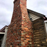 Period brick chimney built by alternative bricklay Period brick chimney built by alternative bricklay