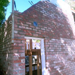 High used red brick wall with angle around door frame by Alternative Bricklaying High used red brick wall with angle around door frame