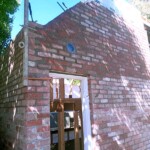 High used red brick wall with angle around door frame by Alternative Bricklaying High used red brick wall with angle around door frame