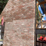High used red brick wall with angle around window frame by Alternative Bricklaying High used red brick wall with angle around window frame